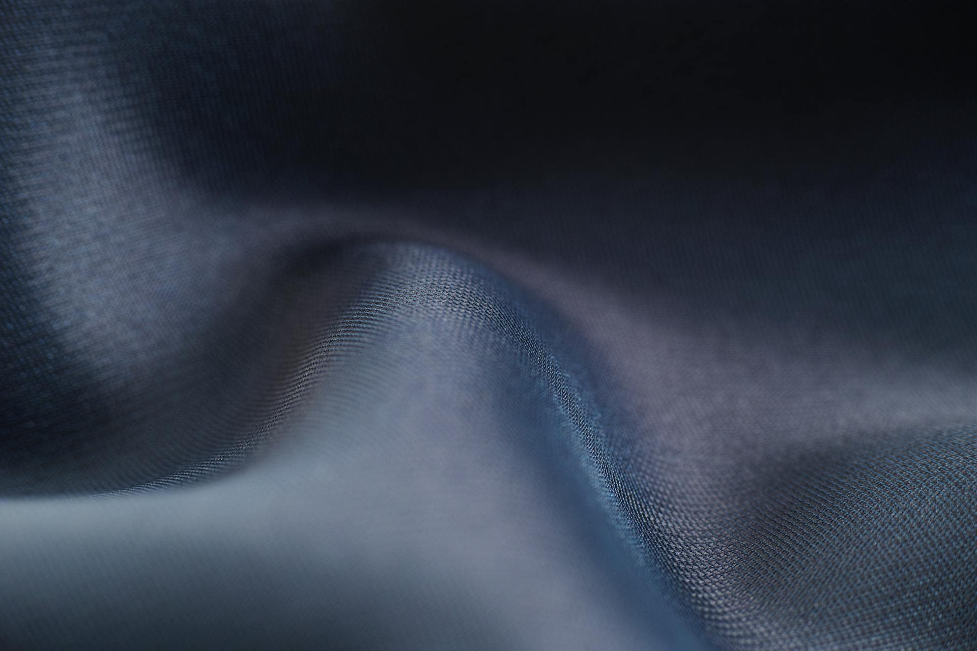 Close-up of flowing blue fabric with smooth wave patterns, evoking the sensation of buttery smooth scrolling