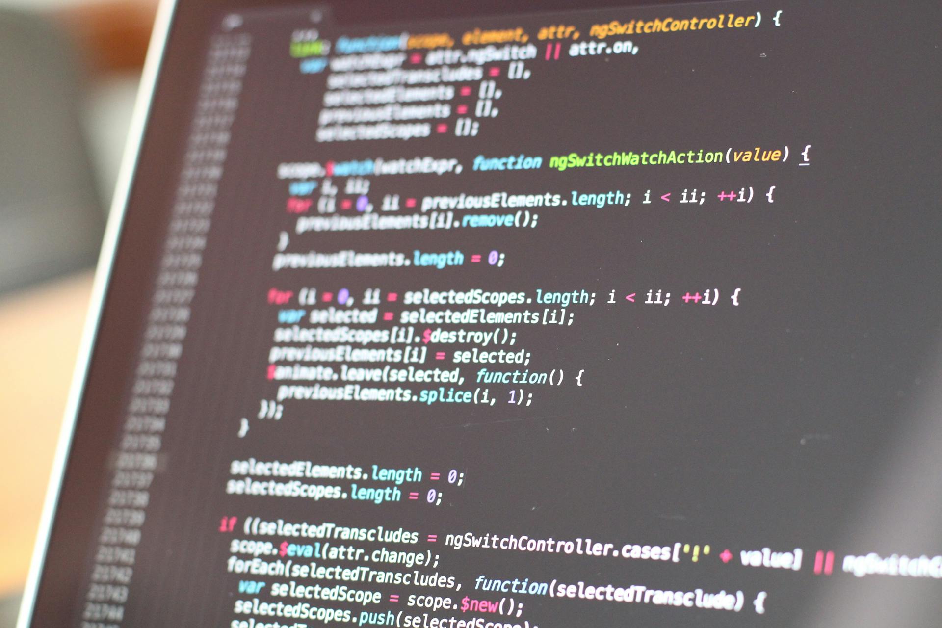 Close-up of colorful code on a laptop screen, showcasing programming concepts